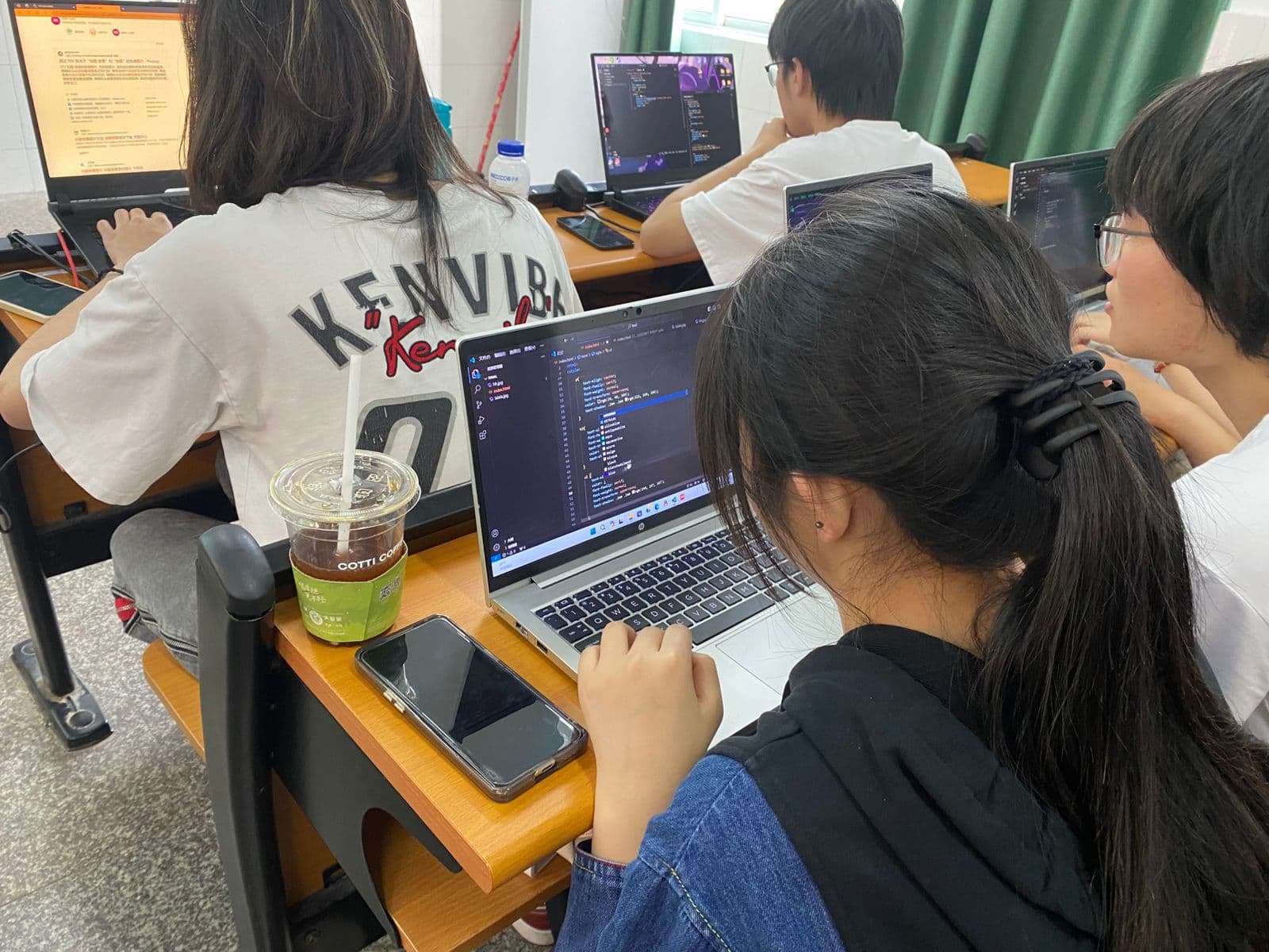 Students collaborating on web development project learning HTML CSS JavaScript at Yango University