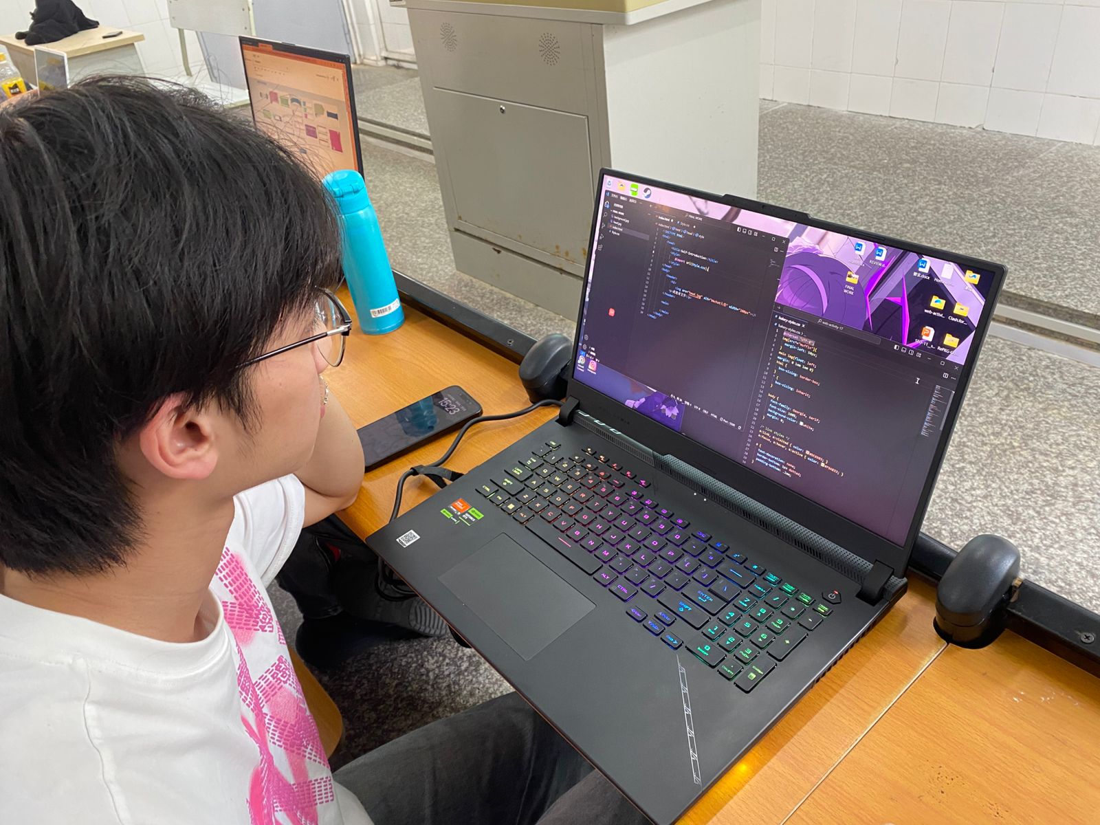 Male student working on web development HTML CSS JavaScript exercise at Yango University